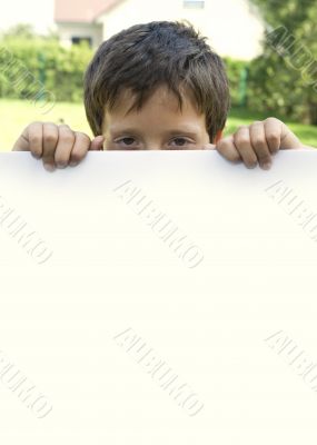 Boy keeps sheet of paper
