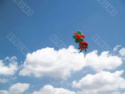 sky with white clouds and balloons in background