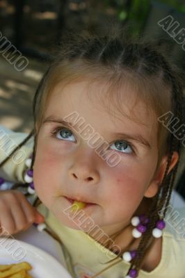 Girl eating french potato Girl eating french potato