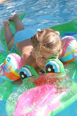 Girl swimming on crocodile