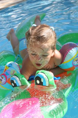 Girl swimming on crocodile