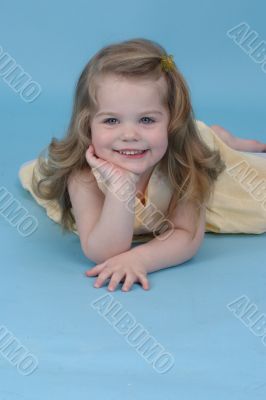 Girl in a blue studio smiling