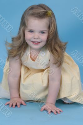 Girl in a blue studio smiling