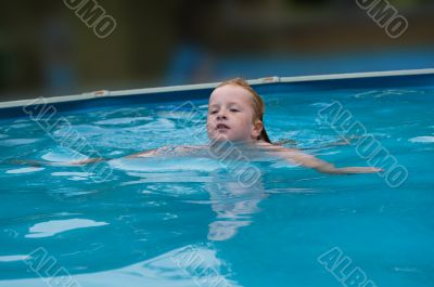 young girl swims in the water
