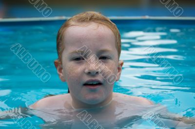 young girl is swimming in the water