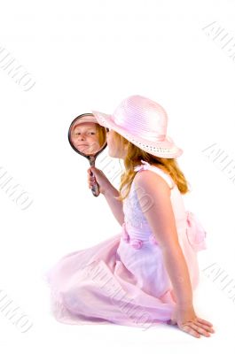 young girl holding a mirror