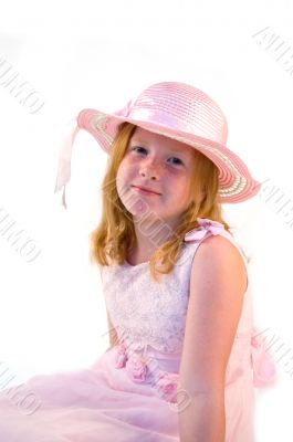 young girl sitting in pink dress