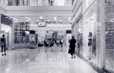 Shoppers at shopping center, motion blur. Tint blue