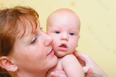 Mother gently holding baby in hands Mother gently holding baby in hands