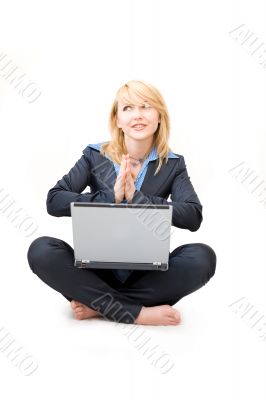 Shoeless woman with laptop do meditative exercises