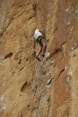 Climber on sheer rock face