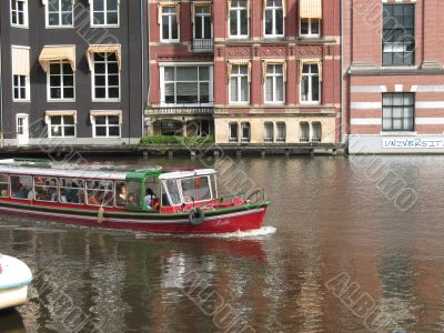 The boat on the canal Amsterdam The boat on the canal Amsterdam