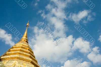 golden stupa over blue sky background with copyspace