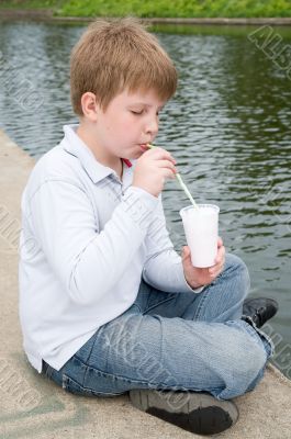little boy drinks a milkshake