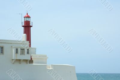 lighthouse over blue sky background with copyspace