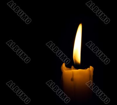 candle flame over black background with copyspace