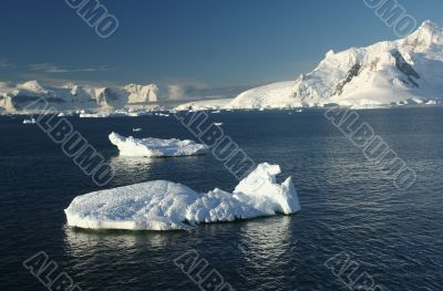 Icebergs, mountains, clear blue sky