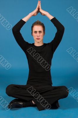 Portrait of a caucasian man in a yoga position