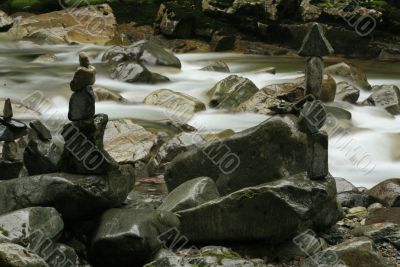 Rock Cairns Stacked Along River