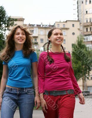 Two happy girls in a city