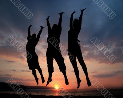 Three people jumping