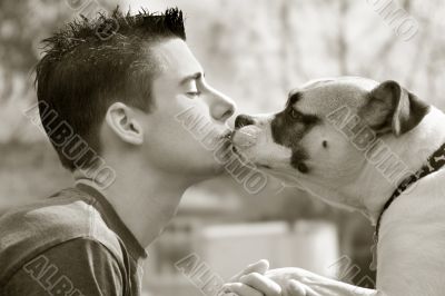 Boy kissing his dog