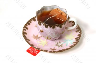 Antique cup with tea bag. Antique cup with tea bag.