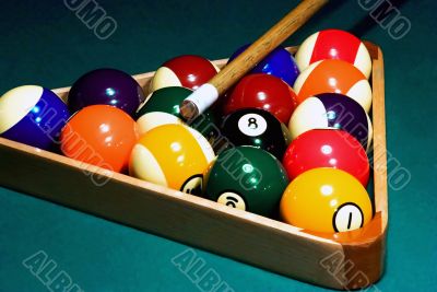 Racked pool balls, and a cue stick