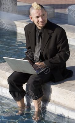 Punk Businessman with Feet in the Water