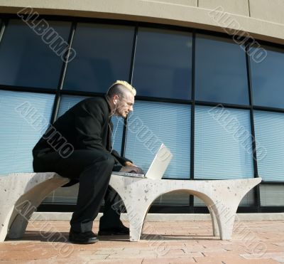 Punk Businessman on Laptop Computer