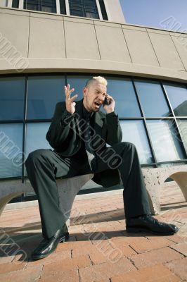 Frustrated Punk Businessman on his Cell Phone