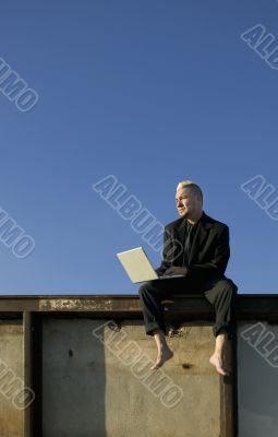 Barefoot Punk Businessman with Laptop Computer