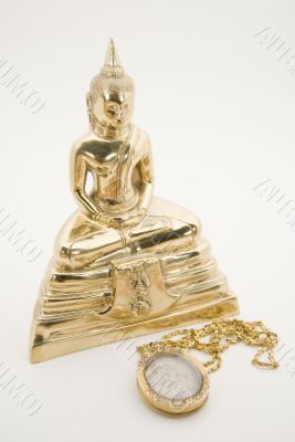 The sitting Buddha and a good luck amulet