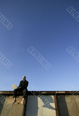 Barefoot Punk Businessman with Laptop Computer