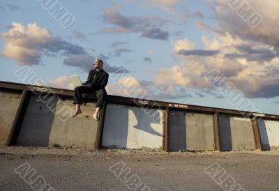 Barefoot Punk Businessman with Laptop Computer