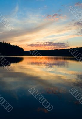 sunset over the lake and forest