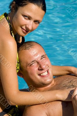 An attractive couple relaxing by the pool