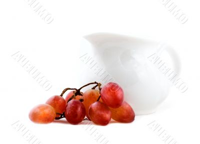 Purple grapes and white pot isolated on white