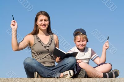 Family with book and pens