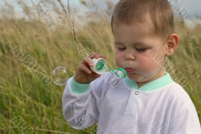Baby with soap bubble