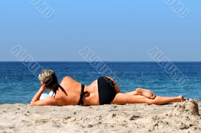 Woman with a book on a beach