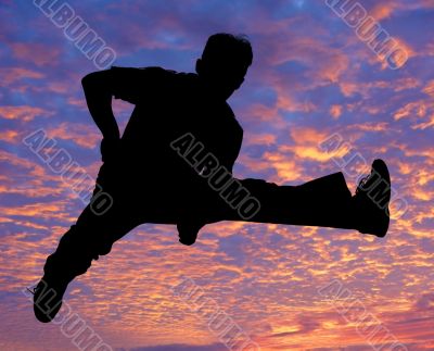 Boy jumping high in the air