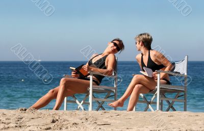 Two Women Reading On The Beach