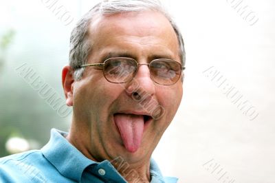 Mature man with his tongue out