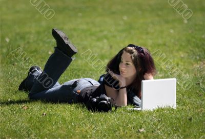 Girl With Laptop On The Grass
