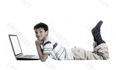 young boy doing homework on a laptop