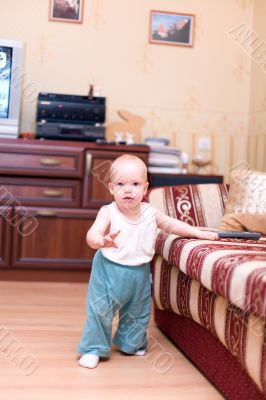 Little boy stand on hardwood floor in typical home interior