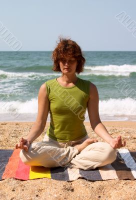 girl meditating on the seaside