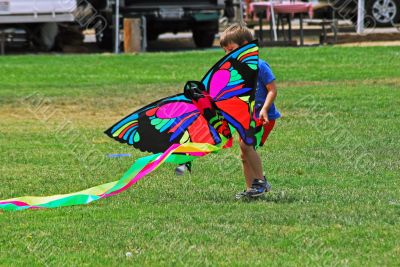 Child playing with a Butterfly Kite