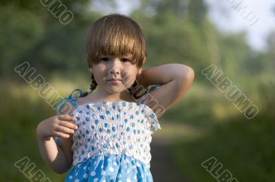 Beautiful girl in spotted dress in sunset lights